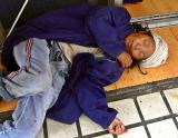 Woman elder laying in the entrance to a business for web access.