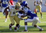 Jackets A-back Orwin Smith moves to escape Blue Raiders S Kellem…
