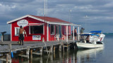 From the sign you can read Ambergris Divers on the red building.