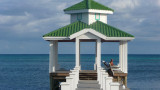 This roofed structure at the end of the dock is shaped like a gazebo.