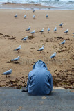 Teen in hoodie on steps at Manly
