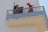 Deux pompiers contrôlent la bonne descente du brancard