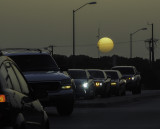 The sun, shrouded by Saharan dust, sets over central Texas