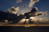 Crepuscular rays breaking the clouds