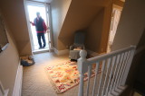 third floor master suite top of stairs facing small balcony