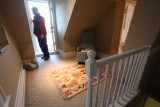 third floor master suite top of stairs facing small balcony