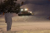 The Woman in Snowsuit and the Snow Groomer