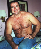 carolina jim sitting on bed undressing.jpg