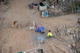Flying low over a local family preparing the morning cooking fire