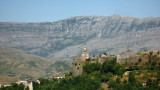 Castle clock tower and mountain range beyond