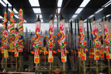 Giant joss-sticks with dragon ornaments and motifs burn outside the temple courtyard.