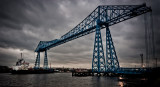 Dredger passing under the Transporter Bridge at dusk