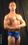 sweaty muscle guy flexing.jpg