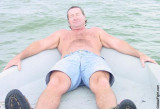 man boating blue jeans cuttoffs.jpg