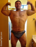 bodybuilder daddy flexing bathroom mirror self photos.jpg