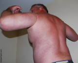 a hairy muscledaddies daddy flexing arms.jpg
