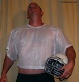 football player holding helmet stomach hairy gut big belly.jpg
