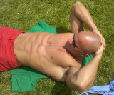 body builder sun tanning poolside laying getting rays hot man.jpg