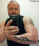 tattooed leather daddie wearing vest wrist straps pictures.jpg
