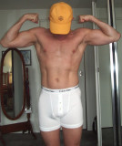 muscledad flexing wearing baseball cap hat hiding face.jpg