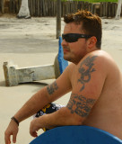 hunks sitting on beach shirtless.jpg