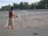 fisher man straightening out his net