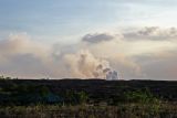 Smoke rising from lava pouring into the ocean