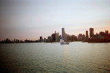 View of a sailboat with part of the Navy Pier showing on the right.