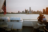 A couple was necking on the deck while watching the sunset.