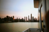 A view of the skyline with the sky turning orange.