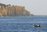 Fishing boat with the cliffs of Île de Gorée