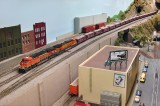 BNSF 7799 leading a short unit ballast train down the main.