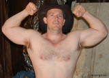 huge muscular cowboy flexing muscles.jpg