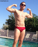 wet guy swimming pool flexing.jpg