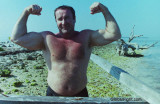 old man flexing beach.jpg