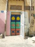 The houses are nearly completely unadorned, but they paint their doors so beautifully