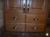 Detail of cabinet hardware. Satin nickel cup pulls and handles.