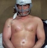 football player sitting resting bench sidelines
