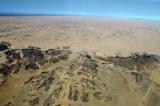 Mountains give way to sandy desert nearing the coast