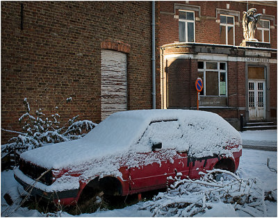 A red Golf under snow