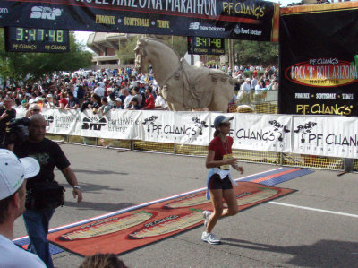 Another runner crossing the finish line