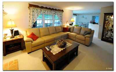 Family room with extra long reclining sectional and new curio cabinet