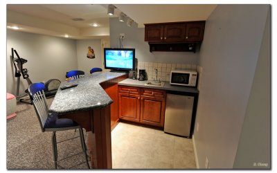 Full wet bar with Granite, cherry cabinets, and of course TV!