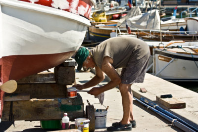 fisherman painting his boat