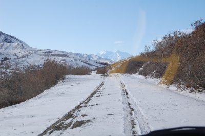 Park Road, Denali in the distance and only two vehicle tracks in the snow