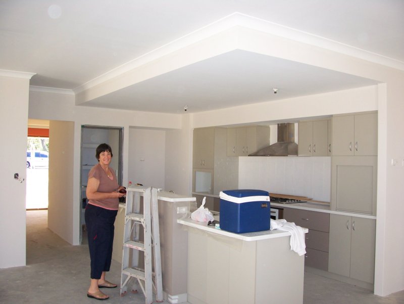 Marcia checking out progress in the kitchen.