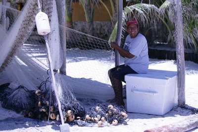 A local fisherman tending his nets