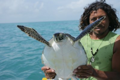 Juan with a sea turtle that took his bait