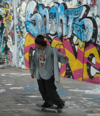 Skating by London graffiti