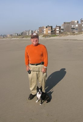 Photographer and his dog with condo behind